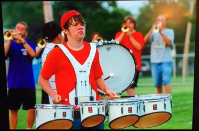 Brendan Smyth playing drums in marching band